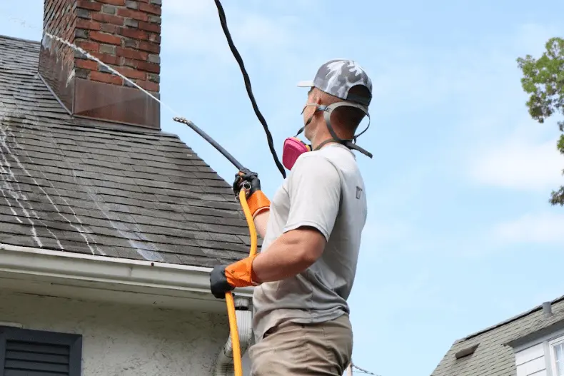 Cleveland Power Washing professional performing gentle roof washing service in Cleveland